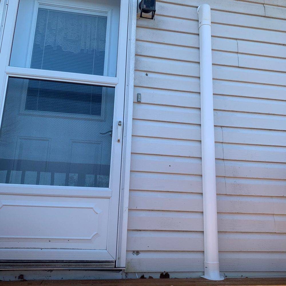 Tidy line set cover running down the siding beside a door